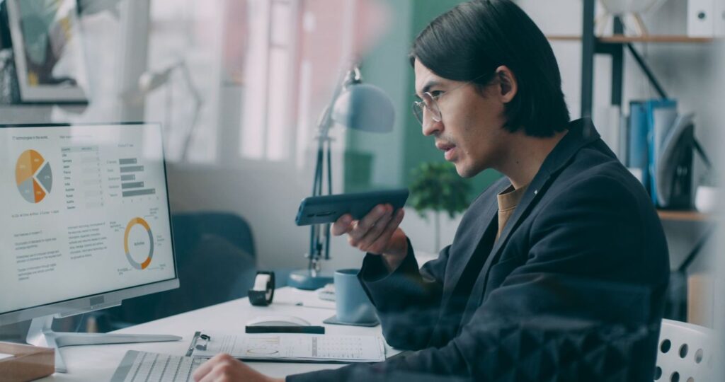 Analyst reviewing a data dashboard with charts on a desktop monitor